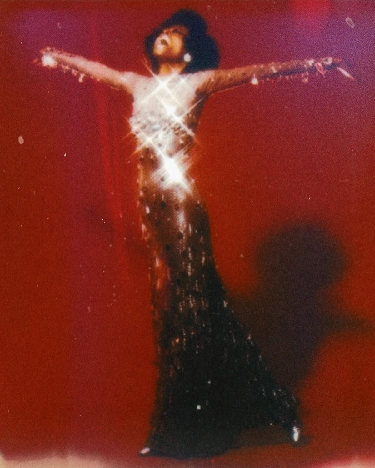 Diana Ross sparkling against red, 1970.